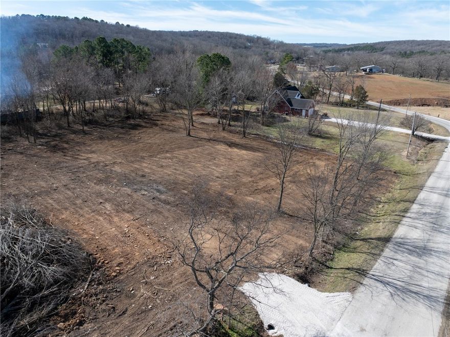 This beautiful 1-acre parcel is cleared and ready to build on! Perc test has been done, city water at the property line, nice view on a paved road, some trees on the property. Preliminary Survey and Perc Test available. Come and see this very attractive property and make it your own! See MLS 1336190