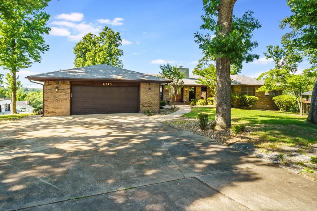AMAZING location with year-round views of Beaver Lake! This single level, all brick home sits on a large, fairly flat, corner lot, just under a full acre. Beautiful views of Beaver Lake can be seen from the expansive deck, living room, sunroom & primary bedroom. The low maintenance composite deck can be accessed from the double sliders in the living room or from the sunroom. This home has been meticulously cared for by the same owners for the past 39 years. The kitchen has original features and is ready for you to update and customize. Natural light pours in thru the large front windows along the foyer hallway. All brick wood burning fireplace is at the heart of the living room. Oversized 2-car garage with room for storage & expanded driveway. Located less than a mile to Hwy 12 & 4 miles to Prairie Creek Marina. Roof was replaced 7-10 yrs ago. Recent updates: new heat pump (3 yrs), new toilets (5 yrs), shutters (3 yrs), wood flooring, sliding windows in back & composite deck.