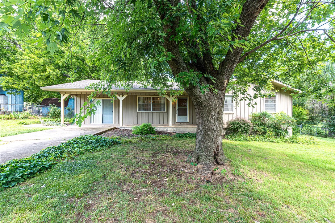 Home sweet home! This 3-bed, 2-bath home, located minutes away from parks, schools, shopping, Highway 62, and a short drive to Fayetteville is just what you have been waiting for! From the covered front porch head inside to this home that features: living room with LVP flooring, L-shaped eat-in kitchen w/ white cabinetry, ample storage, & gas range, bonus room/second living room, primary suite w/ private ensuite & walk-in shower, two additional bedrooms and one bathroom! Out back enjoy an oversized covered back patio overlooking the fenced-in, landscaped back lawn with storage building! Don't miss out—act now!
