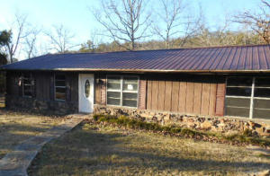 A perfect starter home, or cabin with lots of positive starts. Three bed, 2 bath, Metal Roof, rustic exterior, beautiful land, big open rooms with lots of flooring replaced ready for covering, large carport/storage unit, perfect for a family or single person with pets. Price that almost anyone could afford. $39K
