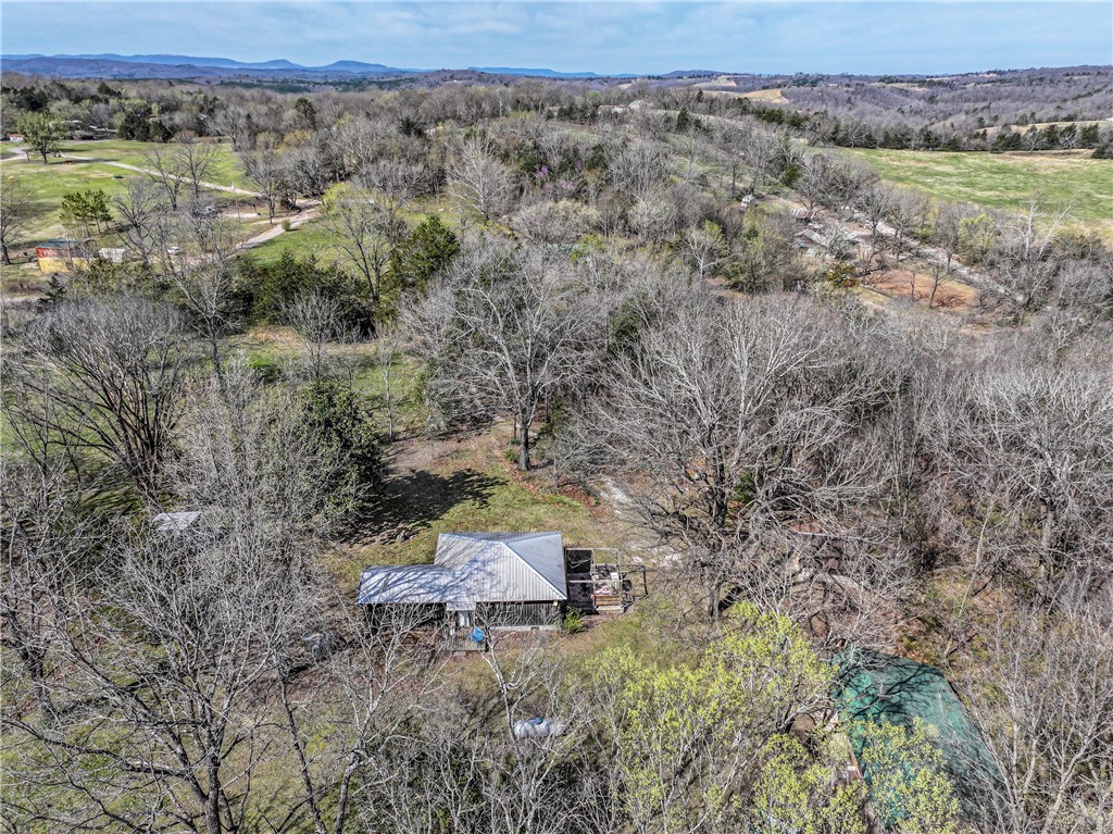 Getaway! 4 miles from Woolum Access and/or from Baker Access to the Buffalo National River. 10 acres (approx. 7 wooded and 3 cleared), Just off paved south Woolum CR. Woolum access is situated on N side of Buffalo River, 7 miles from Hwy 65 at St. Joe. Cabin not visible from road has 2 bed,1 bath and is 1000 sq. ft. Propane Cook Stove/oven, mini split 2024. New metal roof 2022, New Pex plumbing 2023, new cabinets and appliances, New walk-in shower, new insulation, new sheet rock, new siding, new deck and tankless water heater. County water and good well. Bunkhouse sleeps 5. It has a storeroom with hidden closet. A toy garage, storage building, old log cabin and chicken coop.Road Access: first four miles are paved with last 3 graded gravel. Paddling: Woolum access is a popular put-in point for paddling trips on buffalo river. Hiking: Buffalo river trail is a popular hiking and horseback riding trail. is located on S Side of river opposite Woolum access and campground.
