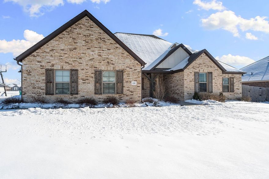 Experience modern luxury in the highly desirable South Pointe subdivision! This stunning 2020-built, all-brick home sits on a spacious 0.31-acre corner lot and features an expansive 3-car garage. Inside, you’ll find a bright, open-concept floor plan with tall cathedral ceilings, crown molding, and beautiful wood flooring. The gourmet kitchen is a chef’s dream, complete with granite countertops, custom cabinetry, a gas range, and a large walk-in pantry.

Originally designed as a 5-bedroom, two main-floor rooms were professionally combined into one massive suite, though it can easily be converted back to suit your needs.

Outdoor living is a breeze with a covered back patio that includes a pergola with a privacy wall, privacy fencing, and professional landscaping. Enjoy neighborhood amenities including a community pool, pavilion, and playgrounds. Perfectly located just minutes from I-49, Arvest Ballpark, Tontitown Winery, and Arkansas Children’s Hospital NW. Welcome home!