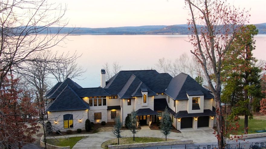 Beaver Lake impeccably designed lakefront home on 2 lots 60ft from the water&#x2019;s edge. Quiet gated community near Rocky Branch. No detail was left out. Ask your agent for a full amenities list as there are just too many to list here. The best are THE VIEWS, the easily accessible 4-stall private boat dock, large underground tornado shelter, central vac, whole house water filtration & softening system, built in irrigation, climate and lighting control from your phone, and high end kitchen appliances(Viking/GE Monogram/Miele Coffee Center). The game room boasts a 2nd full kitchen. All bedrooms have private walk out balconies with gorgeous lake views and en suites. Wood beams throughout home were hand carved on site. Even the toilets are custom! Master Bath has a Toto electric toilet and all other toilets are comfort height level w/soft close lids. This gorgeous home also has custom iron doors and a main level wheelchair accessible guest bedroom. Call today to see the most stunning home on Beaver Lake. Come fall in LOVE!