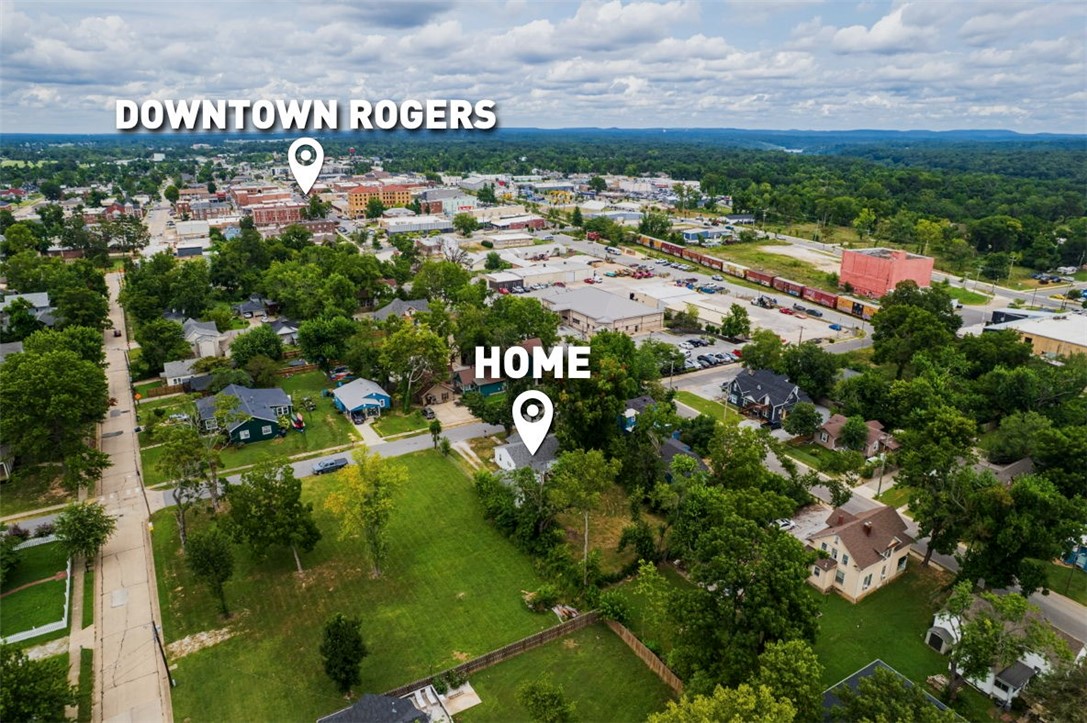 Prime infill opportunity just 4 blocks from the downtown Rogers entertainment district! Set on a .26-acre lot, this property pairs immediate utility with long-term upside. A cozy cottage-style home sits on siteāperfect to hold as a proven short-term rental (previously successful on Airbnb) or enjoy steady interim income while you plan your project. City plans indicate zero lot line development zoning (verify), opening the door for high-density concepts in a walk-to-everything location. Whether you land-bank and cash-flow or tear down and build, this is the rare downtown parcel with scale, shade, and sheer proximity that investors chase. Clean, level site, mature trees, and a neighborhood buzzing with dining, music, and cultureāyour future rental or development starts here. Buyer to verify zoning, development rights, and STR eligibility/permits. Agent related to owner. Property sold AS IS.