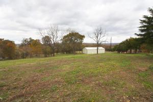 Insulated 30'X60' metal shop building with propane heater sitting on 2 full acres just off of paved highway. Building has concrete floors, is plumbed for a bathroom, and large overhead door for easy access. This could be a fantastic workshop with an office area!