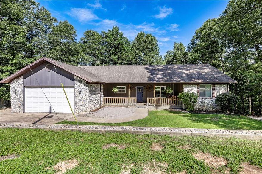 Sweet Deal - Priced under $150 per square foot! Soak in the abundant square footage, swim in the money you’ll save, savor in the equity you’ll create, and spread out with room to grow in this Bella Vista gem ready to make your own. Tucked into a peaceful neighborhood, this warm & inviting 3-bedroom home offers the perfect mix of comfort, nature & convenience. Located just minutes from Lake Ann & nestled between the Back 40 & Flo-Ride Trails, it’s a haven for outdoor lovers & families alike. A large covered front porch welcomes you, while a covered deck & expansive patio overlook the wooded backyard—ideal for relaxing or entertaining. Inside, enjoy a split-bedroom layout with a comfortable primary suite, two cozy guest rooms & an open living-dining area with vaulted ceilings. Kitchen offers bar seating, pantry & connects to the laundry for everyday ease. Walk-out lower level includes a spacious flex area & full bath—perfect for a playroom, media room or office - the possibilities are endless!