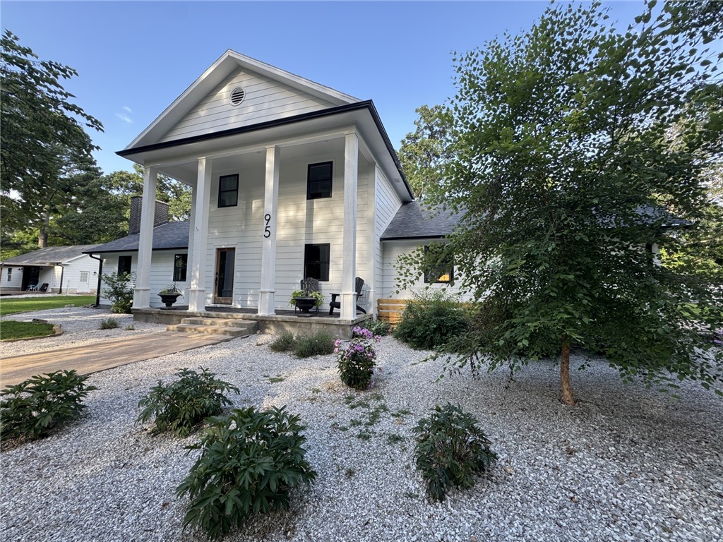 Beautifully renovated older home & guest house w modern features! Complete renovation! Home sits on 1.48 acres surrounded by mature trees. Kitchen has all new cabinets & appliances that include gas burning cooktop, Cafe' french door oven, & built-in combo micro that are both Wi-Fi enabled. Tons of storage! All new LVP flooring throughout the main floor and all new carpet with upgraded padding upstairs in bedrooms. Upstairs has two primary suites with walk-in closets. Office/br downstairs along with a half bath. A separate guest house provides the perfect space for vistors, in-laws, or many other opportunities. Guest house has a full kitchen, bathroom with w/d. Large glass garage door leads to the covered deck making a great entertaining space or perfect game day hang out! Home is nestled in a quiet, peaceful neighborhood that is just minutes to downtown Rogers, Pea Ridge, schools, parks, and more! New mini splits in guest house (2021) and the main house has new air units (2022). All new appliances in both homes!