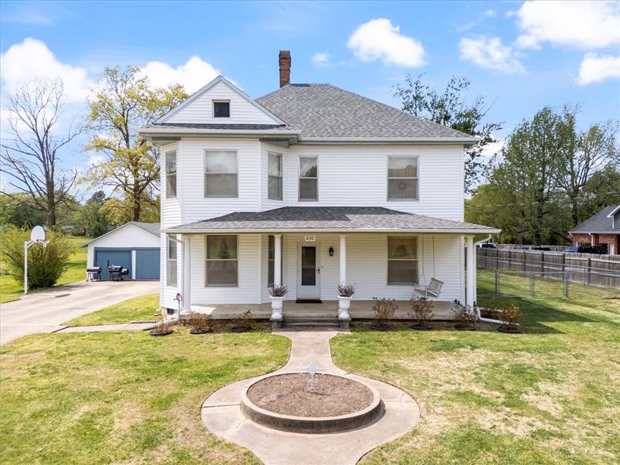Own a piece of history in Siloam Springs! This incredible home, est to have been built around 1895, has been lovingly cared for & thoughtfully preserved. Many original features remain, incl stunning doors, detailed woodwork, vintage hardware, & unique fixtures that showcase its timeless character. Offering 5 bedrooms & 2 full bathrooms, the layout incl one bdrm on the main level & four upstairs, w/ two separate staircases providing convenient access. The main floor feat two spacious living areas, a large formal dining room, & a functional kitchen—perfect for entertaining. Situated on nearly an acre, this property offers in-town convenience with a peaceful, country-like feel. Step out onto the back deck & take in the beautiful western sunsets, or enjoy your morning coffee while listening to birds & watching deer pass through the serene, private backyard setting. Additional highlights include a NEW roof & siding, updated plumbing & electrical, & the original carriage house still standing on the property.
