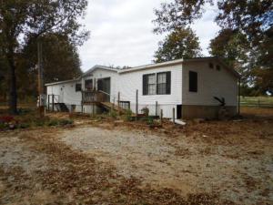 Double wide in country setting; 10 min to town; no central H/A; no water heater; home will need TLC