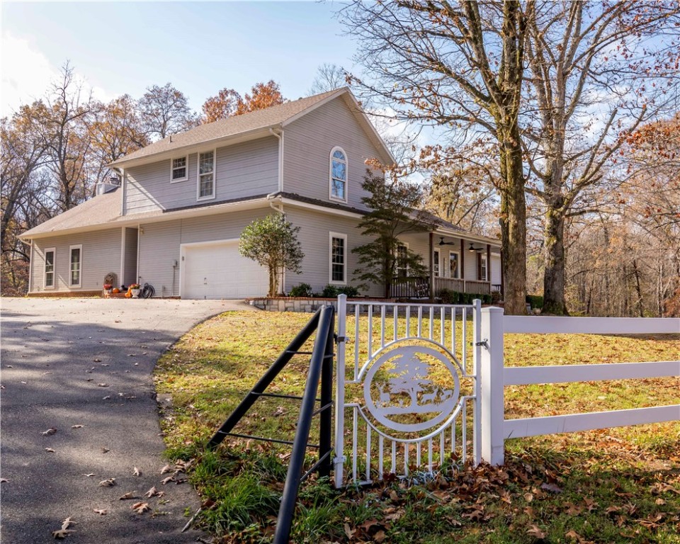 Absolutely phenomenal 17.5 acres off Wedington Drive with a very appealing and upgraded 2908 SF 4 BR 2-story home. Privacy, barn and shop, great views from the house (top of hill), live spring and steel fence across property front, 20x40 inground pool and pool house, 600 SF composite deck with outdoor woodburning fireplace, new appliances and water heater, new interior paint, hand-ripped wood floors, pellet stove in enormous family room, vinyl soffit and facia, 8x30 front porch, 2-car garage and MORE!!