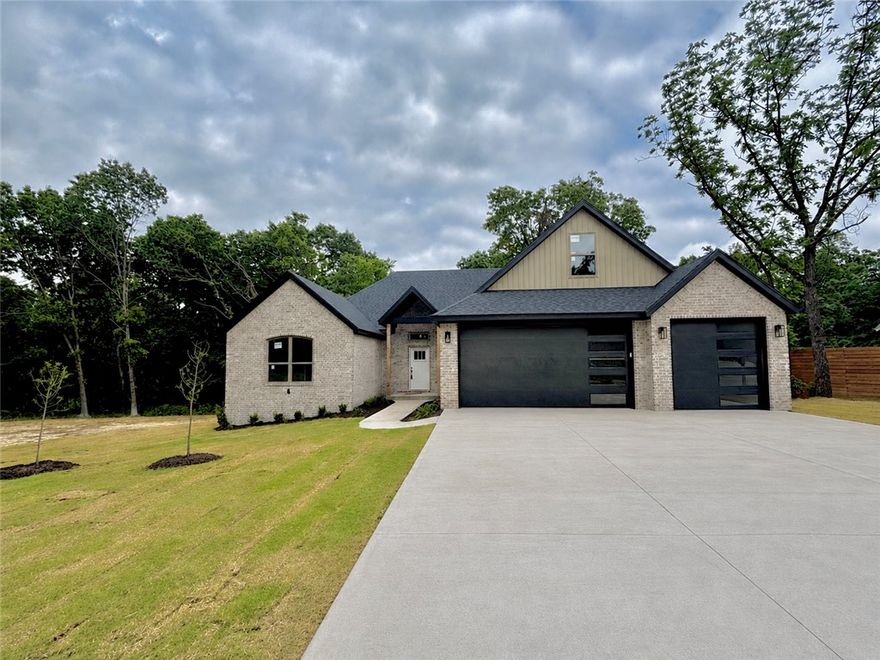 Amazing find-- NEW CONSTRUCTION completed by June 1--This elegant estate home sits on 2 lots (0.6 +/- acres) near Loch Lomond. You will be impressed by all the high-end finishes in this split bedroom open concept floorplan. Main level includes Spacious living area with gas log fireplace, gorgeous beams, & hardwood floors. Gourmet kitchen features quartz countertops, loads of custom cabinets & waterfall island. 2 guest rooms + office. Primary suite with spa-like bath hosts custom tile shower, soaker tub and dual vanities. Primary closet connects to utility area. Upstairs you will find a Media room & 1/2 bath. Enjoy nature on your massive covered deck all overlooking your backyard oasis. Prewired for whole home Generac generator.