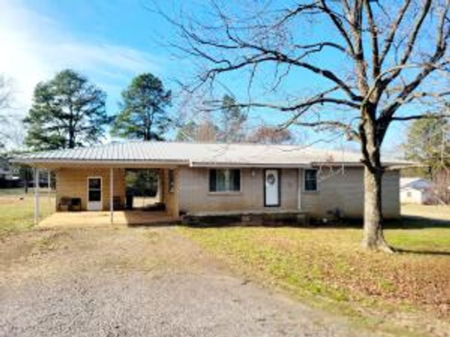 This 3-bedroom, 1.5-bath brick home is situated on a sizable corner lot, offering a serene country setting with endless possibilities. The property includes a functional layout, a covered carport, and solid bones ready for your personal touch or renovations.Enjoy the tranquility of rural living while staying conveniently close to town amenities. The large lot provides ample space for outdoor projects, gardening, or future enhancements to suit your needs.This home is being sold as-is, making it an excellent opportunity for investors or buyers with a vision. Schedule a viewing today and see the potential for yourself!