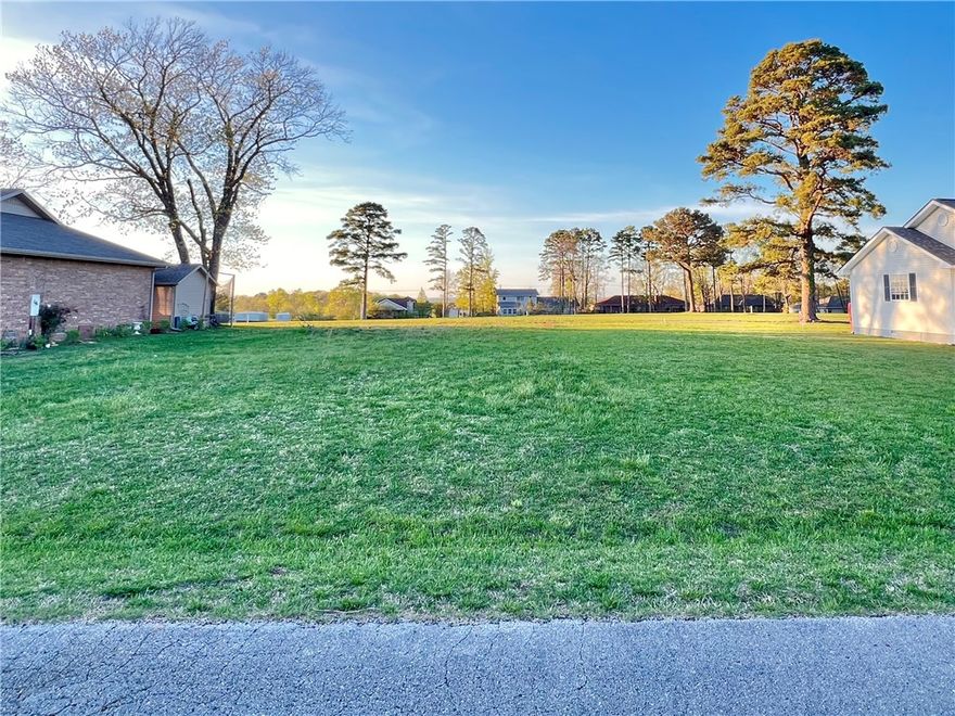 Ready, Set, BUILD!!! Looking to build your dream home near Table Rock Lake? Want property that is centrally located in NWA...this is it. Just minutes from the deep blue waters of Table Rock Lake and the Holiday Island Marina. Downtown Eureka Springs is a short 10 minutes away and boasts 5 star restaurants, colorful night life, art galleries, and several shopping centers. You will also be just about 45 minutes from Branson Missouri to the north and Bentonville to the west. Location is key. You can golf in the early morning, water ski in the afternoon and still make it to Branson for dinner and a show! This lot has already been cleared and is ready for your builder, no extra prep needed and public utilities are on site. This is a quiet side street with wonderful neighbors, but still so close to the country club that you can see it just across the fairway on the back side of the lot.