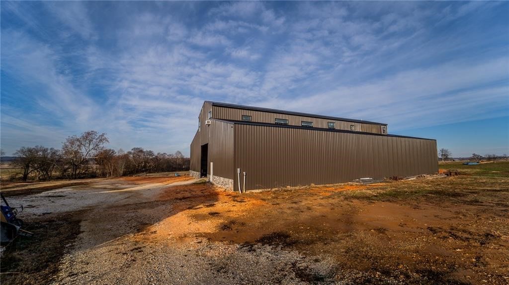 ***Public Real Estate Auction Thursday, October 23th at 10:00AM.*** 5 AC +/- of beautiful countryside. The property is situated along the Muddy Fork River, this custom barndominium is 2400 sq ft and has a huge shop for the first floor. 3 BR, 4 BA and bonus room. The home is under construction and will be sold as is. I highly encourage you to come take a look. Water and electric are on site, septic is needed, successful perc test. Property features a nice detached 3 car detached garage. The hard part is done it's ready to be finished out by the new owner. This would be the perfect place for a construction owner, landscape company, etc. Would also make a perfect place for any family wanting a little room and a nice place to play. It's close to town and all the amenities you could want! Don't miss out on this auction!
