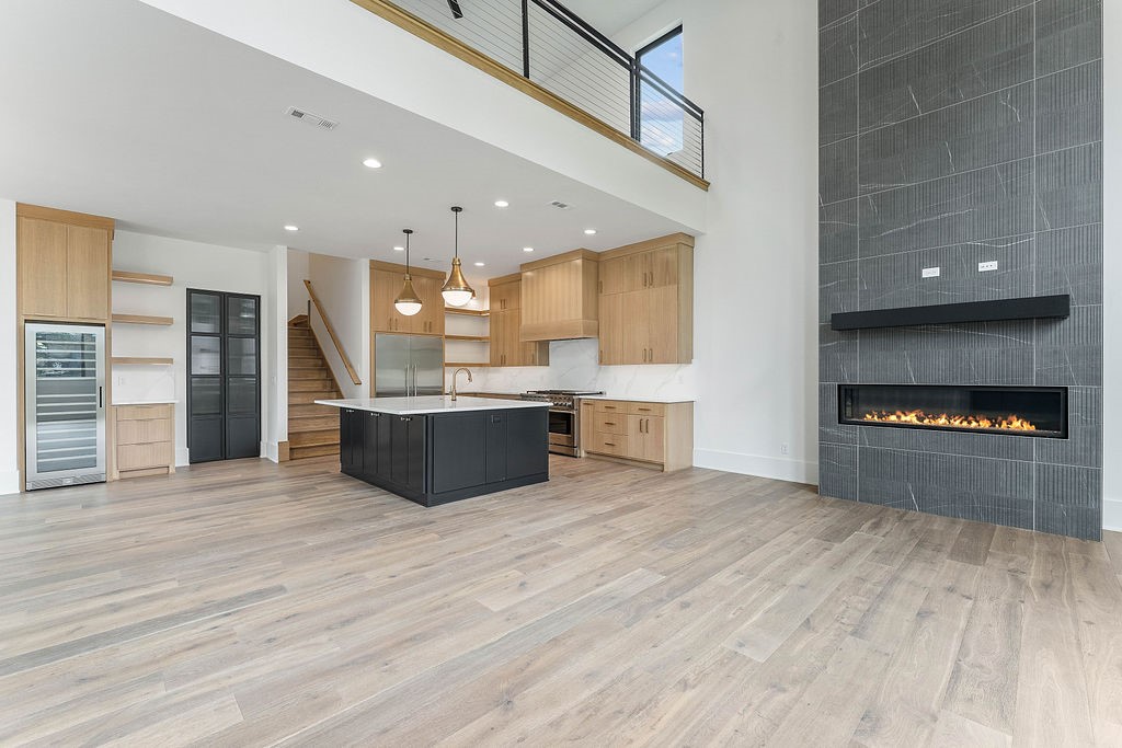 Experience modern luxury living in the heart of downtown Bentonville with this stunning new construction home, designed for comfort and entertainment with seamless indoor/outdoor flow. Boasting 20-foot ceilings, open living spaces filled with natural light, and luxury finishes throughout, this home features a gourmet kitchen with custom rift-sawn oak cabinetry, high-end appliances, a wine and beverage fridge, ice maker, and walk-in pantry. Enjoy the flexibility of an executive office, bonus entertaining room or bar, spacious bedrooms with walk-in closets, and a garage apartment with a separate entry, perfect for a short-term rental or next-gen living. Located steps from the new Walmart Home Office, AWSOM Medical School, Crystal Bridges, and a vibrant community filled with restaurants, shopping, and entertainment, this is your chance to live the downtown lifestyle. Schedule your tour today! Landscaping, fence & driveway to be installed by 6/20.