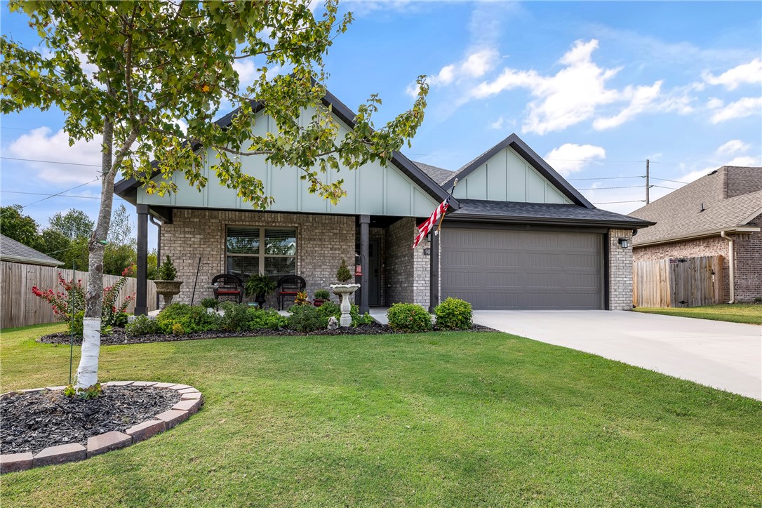 Meticulous maintained home in Hickory Creek in Tontitown. This wonderful 3 bedroom home with 2 full baths has a large covered patio overlooking a big backyard backing up to a wood area. You will love how bright and open the kitchen is with a large island, huge dining area and step-in pantry. The dishwasher has been changed out to a super quiet one. The beautiful fireplace is the main focal point of the living room. This is a split bedroom design with the primary suite up front. The bath features both a soaking tub and separate shower area. The other two bedrooms share the hall bath.