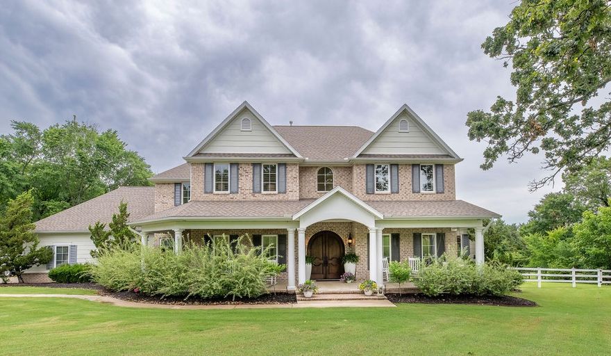 East Fayetteville Dream Estate –This one-of-a-kind estate sits on 2.14 private acres in the Fayetteville school district. With 4,370 sq ft, the custom home blends high-end finishes and seamless indoor-outdoor living. Antique oak doors open to a light-filled sanctuary featuring floor-to-ceiling windows, fireplaces, and designer details like a Currey & Currey chandelier and a grand staircase. The gourmet kitchen boasts a gas stove, large island, custom backsplash, and walk-in pantry, flowing into a cozy hearth room. The family room has soaring ceilings and panoramic doors to a private resort-style backyard with a heated pool, spa, bonfire pit, and screened-in porch. The main-level primary suite offers pool access, his & hers closets, and a spa bath. Upstairs are three bedrooms, a study nook, bonus room, and ample storage. A three-car garage, security, and dog fencing add practicality. Experience East Fayetteville living while listening to the frogs and birds in your piece of paradise.