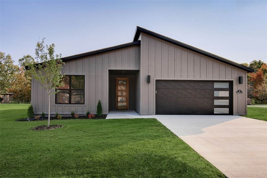 Modern new construction home on a flat .30-acre wooded corner lot. Close to Lake Windsor, the Back 40 Trail, and only 15 minutes from downtown Bentonville! This stunning residence features 2BD's + office, a waterfall kitchen island, premium black stainless steel appliances including a gas range, 3 cm quartz countertops, a walk-in pantry, custom cabinets, & high-end finishes throughout. The inviting living space boasts 10-foot ceilings and a beautiful fireplace, while the oversized custom tile shower adds a touch of luxury to the primary bath. Step outside to the large covered porch—perfect for relaxation and entertaining. Bentonville schools! Approx completion date - 10/15/25. As a bonus, the buyer can receive $3,500 in closing costs when using the builder's preferred local lender.