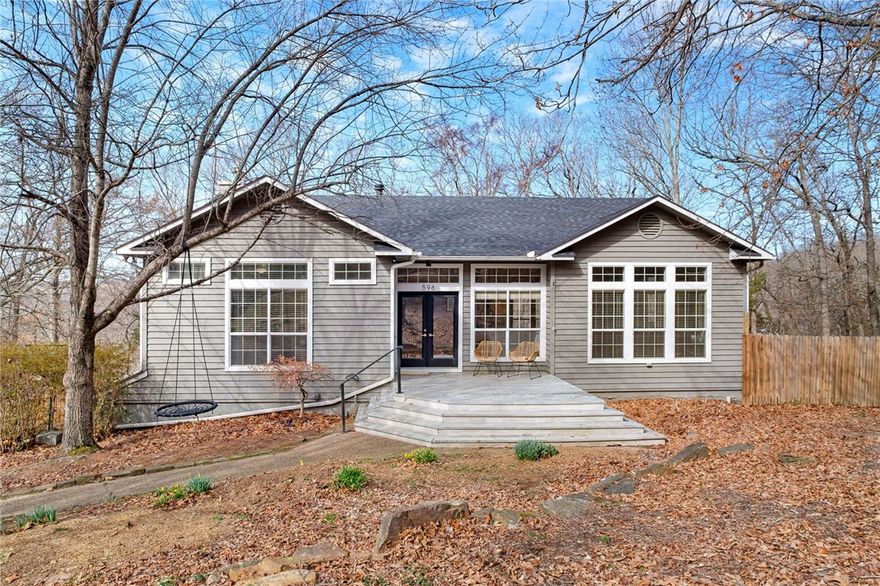 Tucked among mature trees in the sought-after Hyland Park neighborhood of East Fayetteville, this beautiful home offers privacy, charm, and modern updates. A new roof in 2024 adds peace of mind, while expansive windows fill the open living and dining areas with natural light and serene wooded views. Warm hardwood floors, soaring ceilings, and a seamless layout create an inviting space perfect for everyday living and entertaining. The spacious primary suite features tranquil views and private access to the outdoors. Enjoy quiet mornings or relaxing evenings surrounded by nature on the back deck. Conveniently located near parks, trails, shopping, and dining, this home combines comfort, style, and a peaceful setting in one of Fayetteville’s most desirable areas.