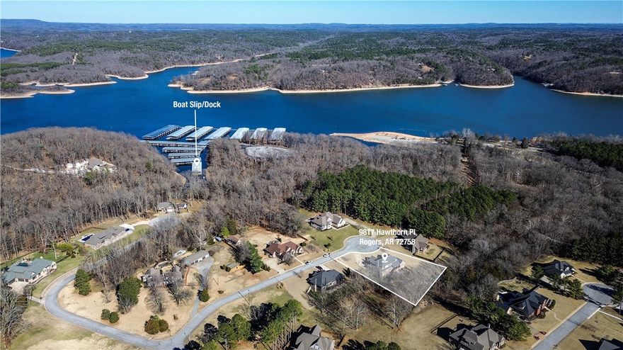 New wood floors are compelete! Say Hello to your lakeside estate! Sitting on 1.01 acres in the gated Avalon subdivision and just steps away from Houseshoe Bend Marina, this incredible custom built 4 bedroom, 3 full baths (2 half baths) home is waiting for its new owner! The spacious living room has beautiful lofted ceilings and a show-stopping floor to ceiling stone fireplace. The heart of the home is the expansive kitchen which features top-of-the-line appliances, ample counter space, and custom crafted cabinets with plenty of storage.  Additional features of the home include an office/study downstairs, 4 car garage, an upstairs bonus room with a wet bar, and an outdoor covered porch with a built in grill.  Expanding beyond the covered porch is an 1800 sqft patterned stone patio with a fire pit and gazebo. A dream home for entertaining!  Call Abby for more information regarding boat slip access and lift.