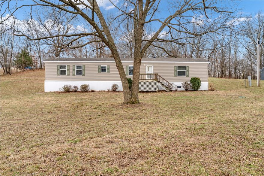 1 acre property in Elkins featuring a 1,152 sq ft Skyline model 2203CT trailer (72' x 16') built in 2009, affixed to a permanent foundation with engineer certification. Includes 2 ensuite bedrooms (one with shower, one with tub) and an added sunroom. Large enclosed shed with electricity—ideal for storage, workshop, or hobby space.