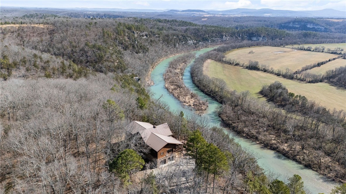 Spectacular Buffalo River Trophy Property | Exclusive River Frontage
An opportunity to own one of the most coveted properties along the Buffalo National River. Spanning over 350 acres across three parcels, this estate offers direct river frontage atop a bluff, with panoramic views of the Buffalo River from the Main Lodge. A combined 11 bedrooms situated over 3 cabins. Hunting, hiking, ATV trails and more all on property. Could be a family estate, hunting getaway, or investment property.
Main Lodge- The heart of the estate is a stunning 4,508 sq ft main lodge, Featuring spacious living areas, soaring ceilings, and a gourmet kitchen. This cabin blends modern comforts with rustic charm. Step outside onto the expansive outdoor decks to enjoy sunset views over the river, gather around the fire pit, or simply relax in nature.
Guest Cabin – 1,804sf, Third cabin - 1588sf
The property also includes a Horse Barn, large detached garage, processing house, and multiple sheds.
Approx 26mi to Harrison 16mi to Western Grove