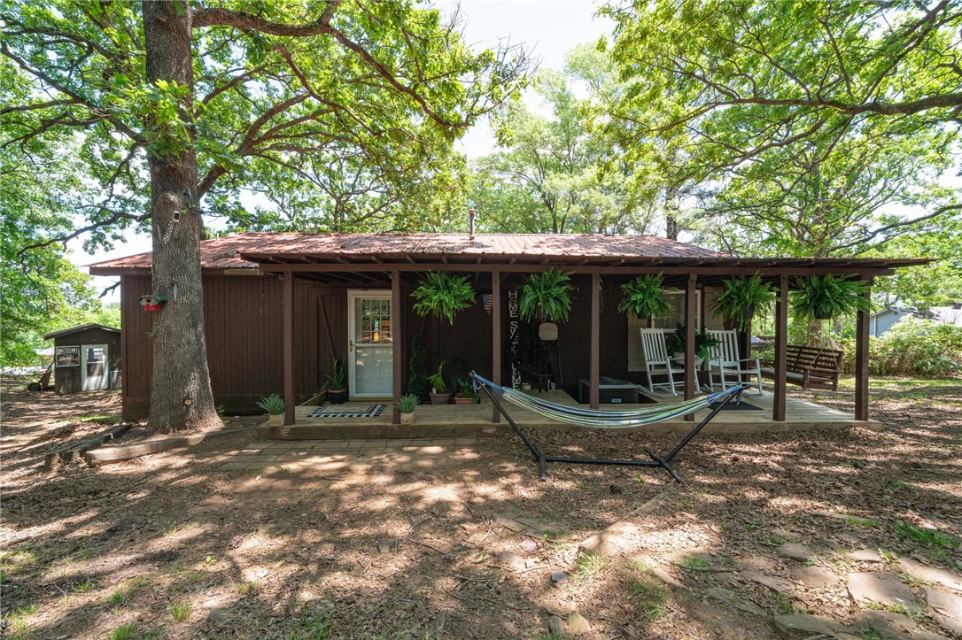 Tucked away in the trees on a spacious lot just outside of Elkins, this unique home offers a perfect blend of comfort, functionality, and natural beauty. With a cozy living space, a den, large bedrooms, and a huge walk-in primary closet, this home is ideal for those who value peace and privacy.
Enjoy the outdoors from the large back deck with scenic views or unwind on the charming covered front porch. The newer metal roof and recent updates include fresh paint, newer flooring, and modern stainless steel appliances with a gas range.
Two versatile outbuildings with electricity provide excellent space for a workshop, home office, or creative studio. Inside, you’ll find thoughtful touches like barn doors, a cozy living area, and an open kitchen that comes complete with a refrigerator, barstools, and even a washer and dryer.
Located in the Elkins School District, this peaceful property offers a secluded feel without sacrificing convenience. HVAC and water heater are only 3 years old for added peace of mind.