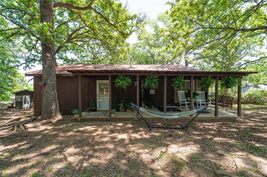 Tucked away in the trees on a spacious lot just outside of Elkins, this unique home offers a perfect blend of comfort, functionality, and natural beauty. With a cozy living space, a den, large bedrooms, and a huge walk-in primary closet, this home is ideal for those who value peace and privacy.

Enjoy the outdoors from the large back deck with scenic views or unwind on the charming covered front porch. The newer metal roof and recent updates include fresh paint, newer flooring, and modern stainless steel appliances with a gas range.

Two versatile outbuildings with electricity provide excellent space for a workshop, home office, or creative studio. Inside, you’ll find thoughtful touches like barn doors, a cozy living area, and an open kitchen that comes complete with a refrigerator, barstools, and even a washer and dryer.

Located in the Elkins School District, this peaceful property offers a secluded feel without sacrificing convenience. HVAC and water heater are only 3 years old for added peace of mind.