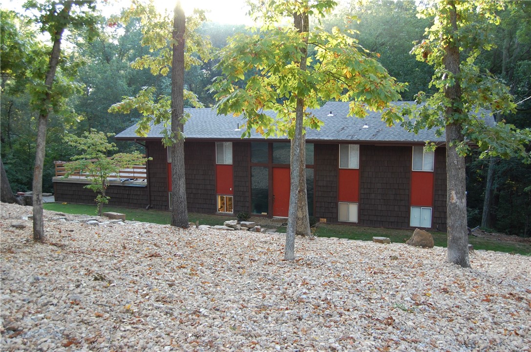 Enjoy the peace and quiet in this rustic and charming home located in the heart of Bentonville! This split level home boasts tons of space, large living room with vaulted ceilings, exposed beams, & wood burning fireplace! This home also features extensive bedrooms, kitchen with double ovens, family room connected to the kitchen w/ wood burning fireplace, large pantry, and multiple decks & patio for entertaining! Excellent location and quick access to one of many bike trails. 5 minute bike ride to Coler Public Parking-water tower trail, 10 minute ride to Slaughter Pen and only 2 miles from Bentonville Square!