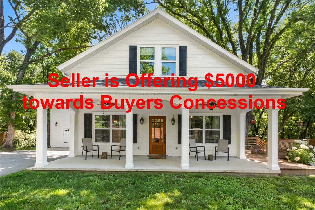 Charming modern farmhouse! This 4–5 bedroom, 3.5 bath home offers nearly 3,000 sq ft of well-designed functional living space. Open floor plan with vaulted ceilings, natural light, and designer touches throughout. Kitchen features large island and flows seamlessly into living/dining areas. Two primary suites, one on each level—offering flexible living. Upstairs primary with hidden storage; downstairs suite opens to private deck. Bonus/media room provides a second living space or entertainment area. Inviting front porch, large back deck, mature trees, and raised garden beds create a serene outdoor setting. Historic outbuilding adds charm and versatility. Private backyard offers a peaceful retreat, while location provides quick access to Downtown Rogers and Walmart HQ. This thoughtfully designed home blends style, comfort, and convenience.