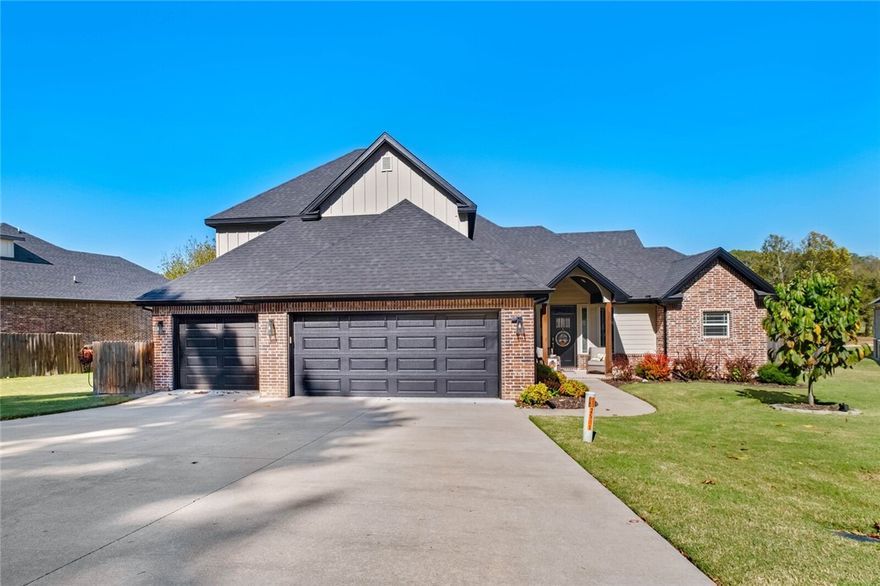 Golf Course-Front Elegance Overlooking Hole 1 Tee Box! This stunning 2021-built, one-owner, 4BR, 3BA home with a bonus room is loaded with custom features. The exterior boasts brick and hardi board, cedar porch beams, and a whole-house gas generator. Inside, the living room features a gas log fireplace and vaulted ceilings with accent beams. The gourmet eat-in kitchen has granite counters, stainless appliances, and a walk-in pantry. A unique extended utility room connects to the owner's bath. The Owner's Suite features dual walk-in closets, a soaking tub, and a walk-in shower. Matching LVP flooring extends into the owner's bedroom and the downstairs office/bedroom. The back yard is great for entertaining with iron fencing for golf course views, an extended composite deck, and a hot tub that conveys. Upstairs includes two bedrooms, a full bath, and a bonus room. Additional perks include a mini-split HVAC in the garage, insulated garage doors, trim lights, and sprinklers with a separate water meter.