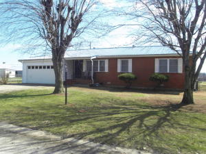 Neat as a pin! Brick 3 BR, 11/2 BA home offers a lot for the price. Lrg Oak kitchen w/breakfast bar, all appl. stay. dining rm w/lovely wood floors opens to sunken den w/gas fireplace. Living room, MBR, and 2nd BR have newer laminate flooring. Covered patio and deck, brick storage bldg., 2 car attached garage. Metal roof. New septic system installed approx 10yrs. 1000 gal. concrete tank.
