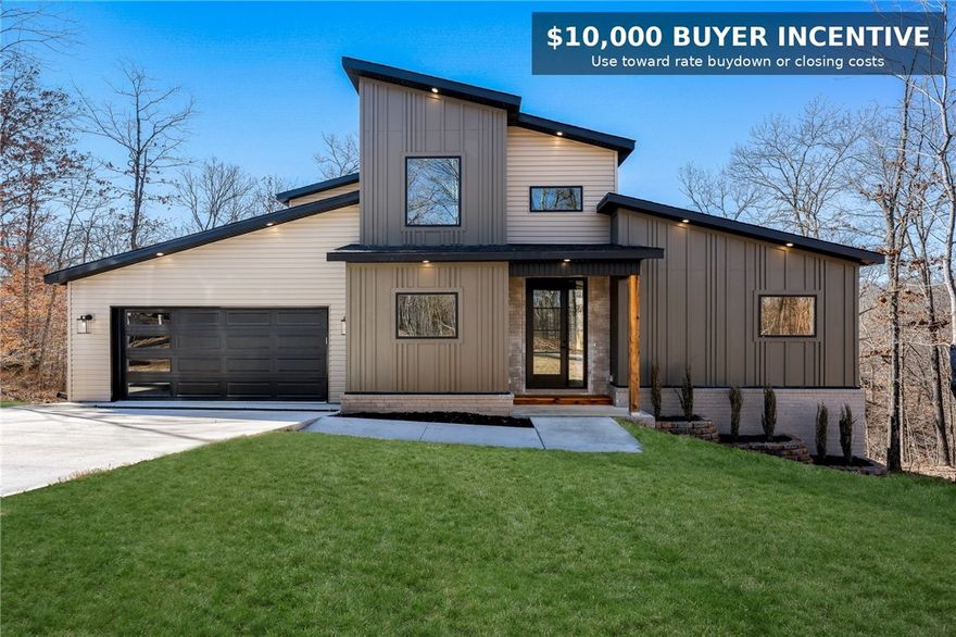 Welcome to 20 Yarrow Lane — a thoughtfully designed contemporary home offering comfort, natural light, and modern living. Located on a quiet cul-de-sac near Loch Lomond and backing to POA land, this property delivers a rare blend of privacy, convenience, and a beautiful wooded setting. The well-planned layout features a private primary suite on the main level, with two additional bedrooms and a versatile flex space upstairs. The open-concept living area feels bright and expansive, with soaring ceilings and abundant natural light, while clean lines and modern finishes create a warm, inviting atmosphere. Prewired for sound and security and backed by a one-year builder warranty, this home is move-in ready for today’s lifestyle. Seller is offering up to $10,000 in buyer concessions—an excellent opportunity to help lower your monthly payment or reduce closing costs.