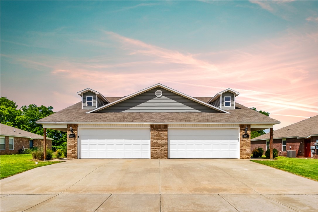 Welcome to the charismatic subdivision of Holland Creek, where quality and affordability meet, on the edge of Farmington and Fayetteville. This beautiful duplex boasts an open-space floor plan spanning across 3 bedrooms, 2 bathrooms, garage, laundry room and lots of serene backyard space. The exterior of the home is finished with a beautiful rustic brick, adding to its exceptional curb appeal. The fully equipped kitchen features a wide island countertop overlooking the spacious living room, abundant storage and plenty of countertop space. The master suite includes both a large private bathroom highlighted by a tile backsplash, oversized-shower and walk-in closet. Hardwood flooring can be found throughout the interior. The laundry room is conveniently located just off the garage and is perfect for any sized family or roommate setup. Essential appliances are included such as a washer and dryer, refrigerator and brand new microwave. Pets are welcome with a non-refundable pet fee. Lawn care included!
