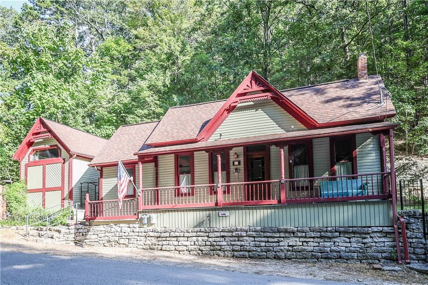 Enjoy prime downtown living in this charming 1900's Victorian cottage with a detached loft apartment nestled along the serene hillside located steps away from everything Eureka Springs has to offer. Featuring a 1,093 sq ft home with 1 bed, 1 bath, a spacious floor plan, gorgeous wood throughout, stained glass, vaulted ceilings, wainscoting, and gas log cast iron stove. Wrapped with an expansive covered porch which leads to a hidden back patio area along the stone edge with a ceiler built into the back bluff. The property also features a 315 sq ft loft apartment with 1 bed,1 bath with a sleeping loft, a kitchenette, cathedral ceilings, plenty of space to be utilized as a guest house for monthly income or could be used for family and friends. Must see to appreciate!