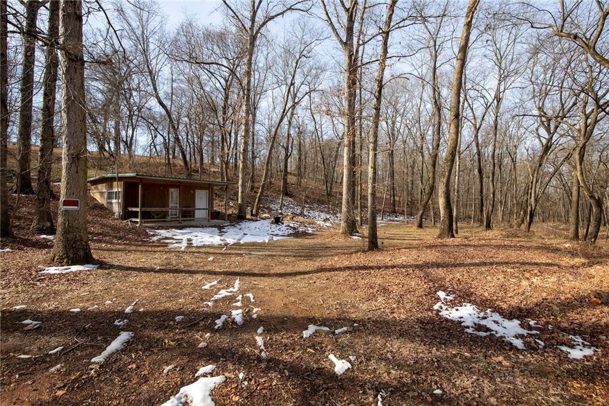 Rare opportunity to own 6 scenic acres in Northwest Arkansas with a small cabin already in place. Tucked away in a quiet, wooded setting, this property offers a private retreat surrounded by mature trees and abundant wildlife. The land provides a peaceful escape while still being conveniently located near area amenities, dining, and recreation. Whether you’re looking to build your dream home or create a weekend getaway, this versatile parcel offers both seclusion and accessibility in one beautiful setting.