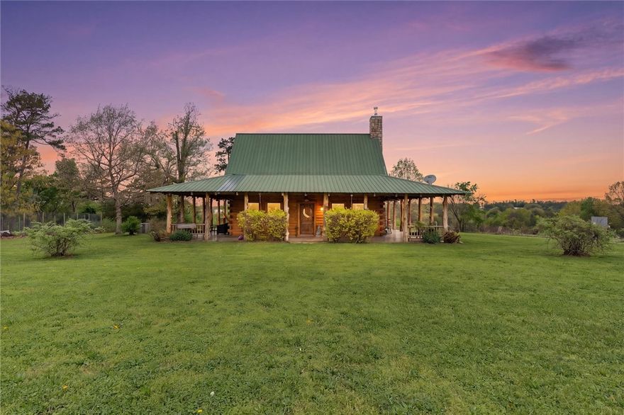 Escape to the Ozarks with this unique 18.7-acre retreat in scenic Madison County, just 30 miles from Rogers, 16 from Eureka Springs, and 12 from Huntsville. Nestled in a private, peaceful setting, it blends rustic charm, recreation, and self-sufficiency. The 960 sq ft log cabin offers 1 bedroom, 1 bathroom, and a cozy loft—ideal as a getaway or full-time home. A few steps away, “The Bunker” is a 30x50 metal building with a 30x30 garage/shop and has 1083 sq ft of living space for guests or extended stays. Beneath it, a hidden-entry underground bunker with beds and a secure vault adds a rare layer of functionality. Enjoy excellent hunting, with access to Madison County WMA’s 14,500+ acres just across the road, plus nearby Kings River for fishing and floating. A versatile retreat with unmatched features.