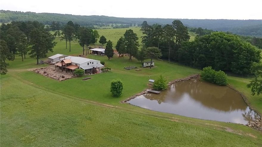 "Extraordinary" fails to convey the sentiment of this 300 acre waterfront property. The secluded ranch with an 8 mi Western view of the Arkansas River lays just North of Ozark, AR in Franklin County. The 3700 sf house built in 2002 has 3 bd, 2 bath, 1 half bath and is on the River's North side with pastures, timber and trails to the 10 acre lake which is ideal for duck hunting and fishing. Inside the gates are 80+ acres of cross-fenced pasture that extends past the vineyard to the 2 cabins w 1bd/ba ea., a Chapel with a reception area & bar, a pole barn, hangar & 1500' airstrip. A perfect site for a wedding venue and/or party site with ample room for guests to stay. The turkey & whitetail deer are abundant with Ducks that rest on the Lake. Of course, small game like rabbit & squirrel are plentiful as well. Oil and gas rights convey with the sale of the property as do any of the water rights and mineral rights the owner may have.
