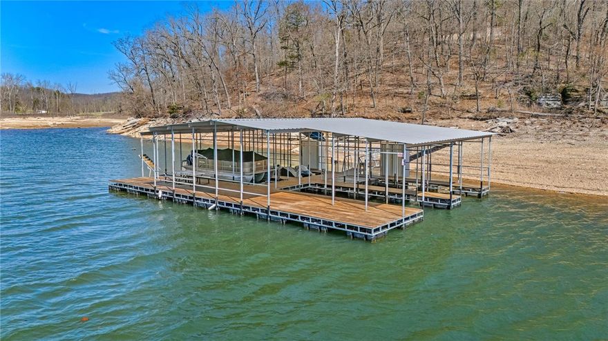 17 Acres | 400+ Ft Beaver Lake Frontage | One of the Last Permitted Docks on the Lake

Rare doesn’t begin to describe it. This 17-acre Benton County property delivers over 400 feet of Beaver Lake shoreline, a brand-new (2023) 4-slip dock with 10 x 30 ft boat slips, & a 14 x 66 ft semi-covered swim deck-one of the last permitted docks allowed on Beaver Lake. An updated 2,156 sq ft, 4-bedroom, 2-bath home sits elevated on the property, offering privacy & partial winter lake views while the shoreline below offers direct access to the water in a protected cove. The property features a beautiful mix of mature Ozark hardwoods, creating both usability & natural privacy. Approximately 6 acres of prime lakefront land present a unique opportunity for expansion-whether that’s additional homesites, a luxury compound, or a thoughtfully designed development. Conveniently located just minutes from Rogers and approximately 40 minutes to Bentonville and the new Walmart Home Office. Opportunities like this are rare—don’t miss it.