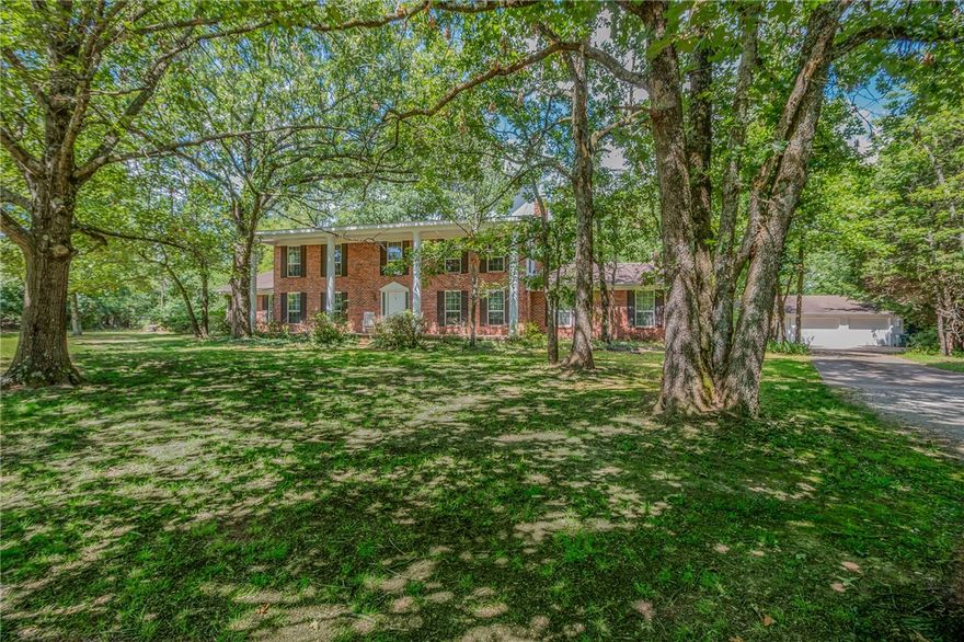 Set back along a sweeping drive for privacy this Georgian style home exudes original character & charm. Located in one of Fville’s highly sought-after areas w/4 BR’s on 1.84 acres. Main level hosts casual/formal spaces w/FP plus primary suite w/walk-in closet. Eat-in Kitchen w/bar seating, double ovens, custom cabinetry w/wall pantry & pull- out slides. Generous rooms & seamless flow include impressive sunroom w/wet bar for those who love to entertain. Floor to ceiling windows & slider doors offer views & lots of natural light w/access to deck & grilling area. Great laundry room w/storage. Second level boasts additional primary BR & bath w/office/flex area, 2 more guest rooms & full bath. Large bonus w/separate craft/exercise/space completes upstairs. Enjoy outdoors from covered front porch, back deck or create your own outdoor sanctuary nestled in the trees. Detached 3 car garage w/room for a workshop. This delightful home invites you to embrace endless possibilities. Sold AS IS. Agent related to seller.