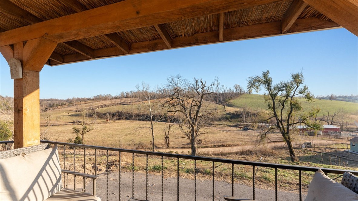 Whether you're looking for a home that allows you to hunt in your backyard, raise livestock, garden, or simply sit on your front porch and enjoy views for days - you've got to see this property! This home has had numerous updates including: new well system and carbon filtration system, new wood stove installed and chimney serviced/repaired as needed, NEW WINDOWS, attic insulation added, and proper grating and gravel added for proper water flow and to prevent erosion, and septic tank cleaned out in 2022. Hassle-free ceramic tile "wood look" floors throughout. The shop is 30x40 and has electricity established. The beautiful 14.42 acres has both pasture and wooded portions, plus a pond, allowing for numerous options for use. Easy access to the beautiful War Eagle Park and Hobbs State Park.