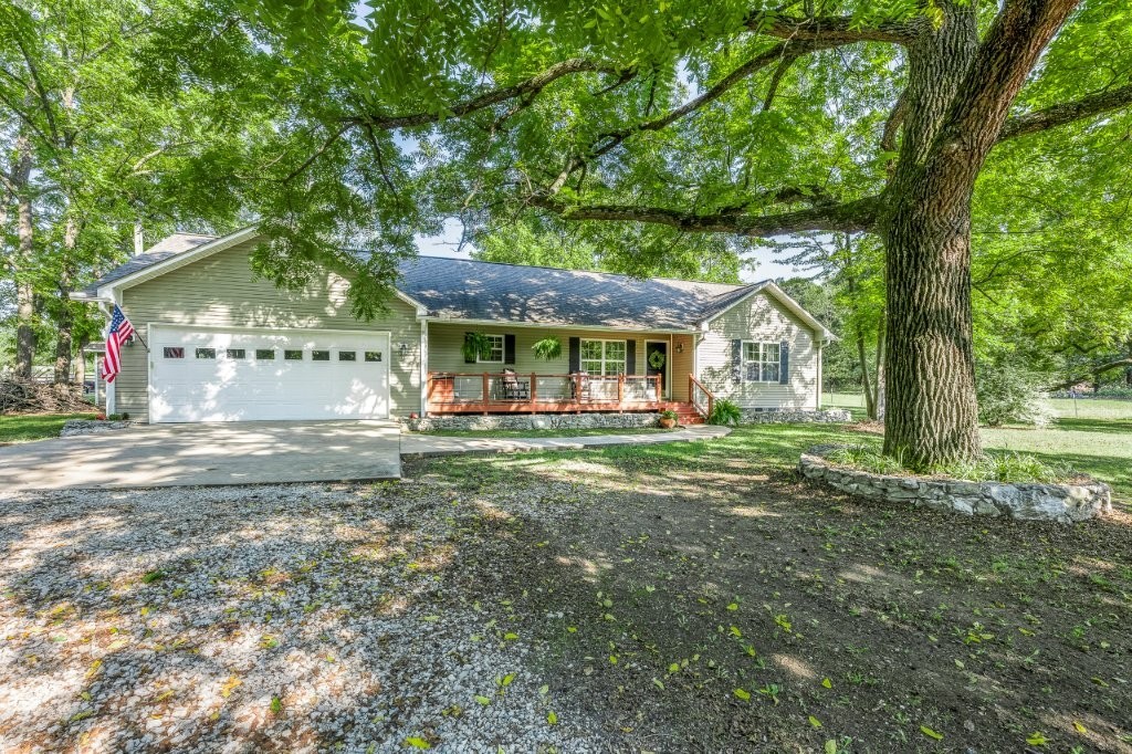 COUNTRY LIVING AT ITS FINEST! Extremely well maintained 2 bedroom/1.5/bath home & 30x40 Metal Shop, sitting on 5 fenced lush acres (a few mature trees, mostly cleared & ready for your farm animals)! Enter thru the new solar powered metal gate to your private oasis. Stunning Open concept floorplan features Spacious Kitchen with tons of custom cabinets, granite countertops, & Huge Island. Cozy breakfast nook with wood burning stove, large living area, perfect for entertaining! Don’t miss the 9x7 storm shelter/safe room in the garage! Unbelievable Shop has 2 garage doors,12x40 side porch & 18x30 RV carport. A true 1-of-a-kind property near shopping, city park, & splash pad. Don’t miss this rare opportunity!