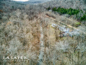Looking for land with a creek? 24 acres with Possum Trot creek running through it! Swim in the swimming hole all summer long. Property has multiple springs on it as well. There is a single wide mobile home with 3 bedrooms 1-1/2 bath. A 2nd mobile home that can be restored & another old house place with septic and electric. Less than an hour to Fayetteville and Harrison. Enjoy the seclusion and peace close to the Buffalo River! The water source for the home is a gravity flow spring. There is also a well they use to water the garden