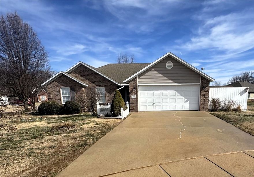 Move in ready home on a big corner lot in an absolutely phenomenal location directly across from Gentry High School. Walk to school and enjoy all the sports played there. Open the door and you're greeted by brand new carpet in living room, hallway and bedrooms. Spacious living room has vaulted ceiling, gas fireplace, large window beaming natural light throughout and opens to kitchen so you can cook and still be engaged with family. Kitchen features plenty of counter space, lots of cabinets with under lights, pantry and dining area. Primary bedroom at back of the home features a trey ceiling and has a walk-in-closet and a full ensuite. Two more generous bedrooms on the front of the home allow plenty of space for the kids. Garage has gas wall heater, storm shelter big enough for entire family and floored attic with rotor and antenna. Out back there is a big 10x20 concrete patio, 220 plug for hot tub, multiple sheds and workshop with electricity and a space for parking trailer or boat. Furnace and AC only 3 years old.