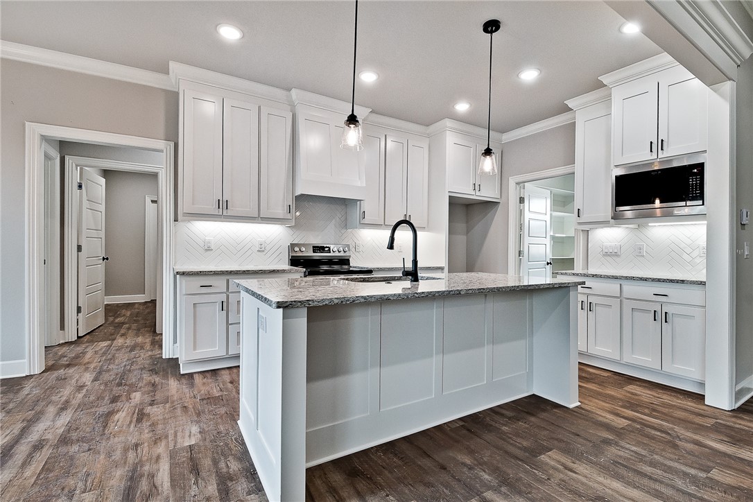 **SELLER OFFERING $5,000 IN BUYER CLOSING COSTS OR UPGRADES** This beauty is located just three miles from I49...talk about convenience! This three-bedroom, three bath split floor plan PLUS office AND bonus room has an abundance of space for entertaining. The floor plan is not only perfect for souls who like to entertain, but built to make everyday life easier - Equipped with a 9x9 walk-in pantry WITH coffee bar for the longest days, the laundry room is connected to the master bedroom with granite-top utility sink for the dirtiest days, and an oversized two-car garage for the most cluttered days. Exquisite finish work includes crown molding, custom trim, gas stove, 3cm granite, under-cabinet lighting, luxury vinyl plank, and a concrete pad in crawl for storage. *Taxes are based on an unimproved lot. Photos do not reflect gas stove.*