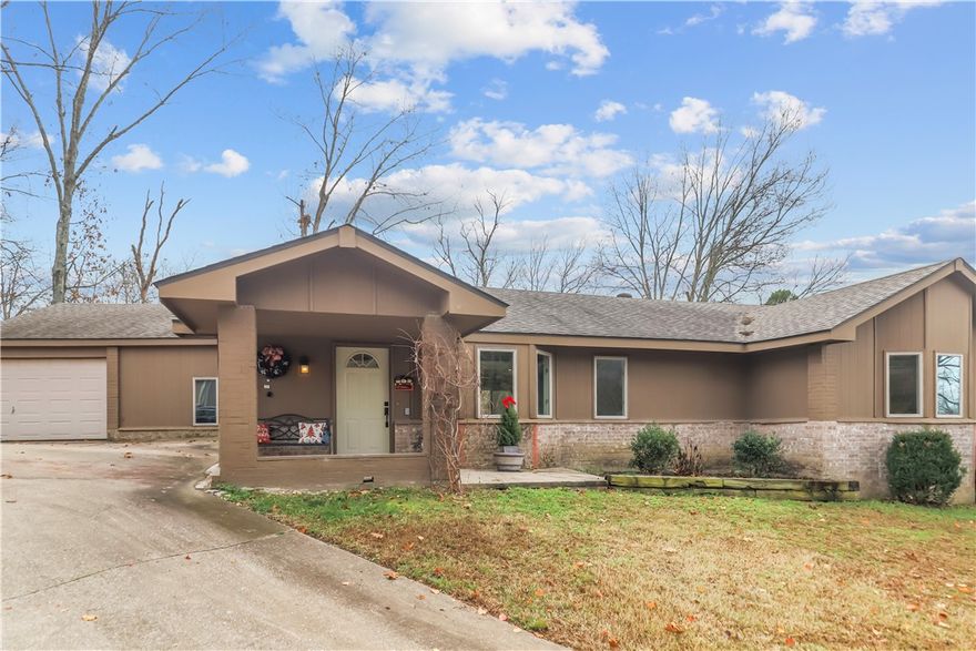 This Bella Vista retreat is an entertainer’s delight. Enjoy a peaceful backyard with a wood-burning fireplace, covered gazebo, and forest views. The backyard is also relatively flat so there are many options for upgrades. Inside, the open floor plan flows beautifully with low-maintenance wood-tile floors. The home features two primary suites, each with a walk-in closet and walk-in shower, plus a built-in desk and shelving for work-from-home convenience. 
The kitchen overlooks the backyard and includes granite countertops, Samsung appliances, a granite composite sink, and a large walk-in pantry. The heated garage (not included in the home’s square footage) adds versatility with a cedar closet for extra storage, and a third full bath, perfect after hitting the Bella Vista MTB trails.
Located on sewer, the property offers plenty of options for future expansion. Additional side parking provides room to pave or even add a shop. Whether this is your dream home or MTB getaway, it’s one you won’t want to let slip away.