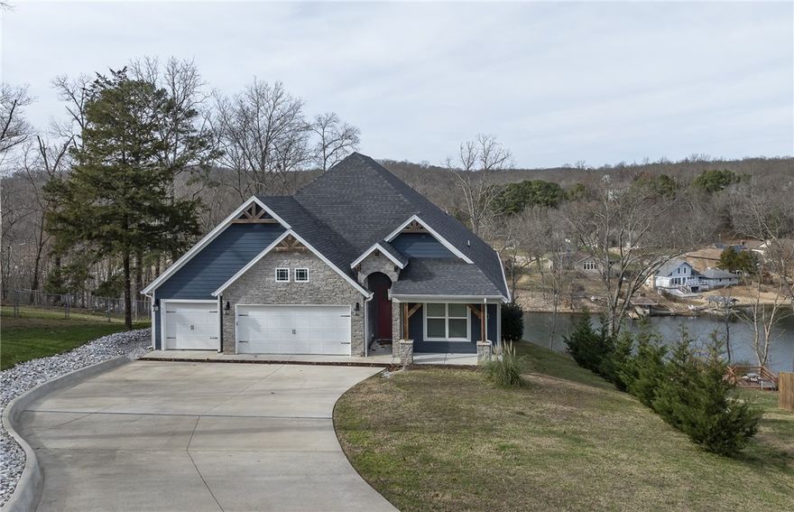 Now offered at $1,050,000, this custom lakefront home on Lake Windsor in Bella Vista, AR offers panoramic water views, flexible living spaces, and a prime location minutes from Bentonville. Set on a 0.62-acre lot with approximately 80 feet of private lake frontage, this 3-bedroom, 3-bath residence features 3,694 square feet across two levels.

The main level showcases vaulted wood-beamed ceilings, expansive lake-facing windows, and an open-concept great room ideal for everyday living and entertaining. The primary suite includes lake views, a custom tiled walk-in shower, and a walk-in closet with direct laundry access, along with a second main-level bedroom and full bath.

The walk-out lower level offers a second living space with a full kitchen, oversized living area, full bath, third bedroom, and versatile bonus room for an office, gym, or studio. Built in 2019 with all-electric systems, tile flooring throughout, and a 3-car garage. Enjoy Bella Vista amenities, lake recreation, and easy access to Bentonville.