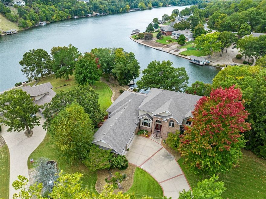 Rare Opportunity to immerse yourself with this stunning combination of a custom dream home & lake living with meticulous attention to detail & craftsmanship setting this home apart & above all others. Well sited on one acre in a quiet cove and yet encompasses stellar views of the lake, with impressive large floor-to-ceiling windows throughout. Floorplan is open, comfortable, & inviting with a flair of European style. The park-like landscape extends to an easy walk to the boat dock. Main level, includes primary suite & guest rm., living rm., family rm., /with pass-thru fireplace. Upper level, office, studio & 1/2 bath. Lower level, 2 bedrooms, full bath, 2nd family room & workshop, w/loads of storage space. Meticulously maintained one-of-a-kind high-end quality construction by renowned Van Construction. New roof 2020, HVAC 2017, hot water heaters 2020, appliances 2017, sea wall 2017. Stone sea wall extends approx. 360 ft. This property has the WOW factor. Pool Table Included.