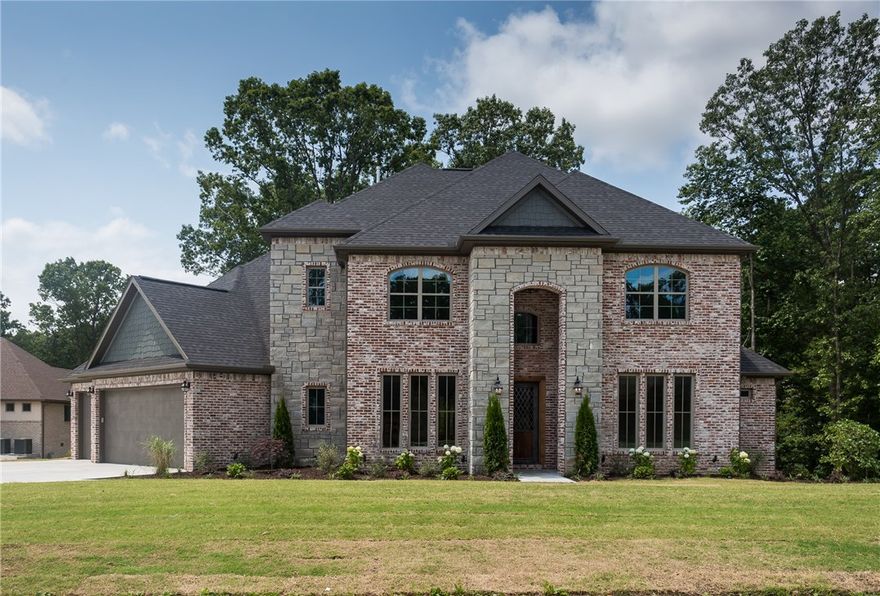 JSN Properties of NWA home with reclaimed brick exterior. 2 beds down/2 up, barn door opens into media room w/2nd floor covered balcony overlooking backyard. Floor to ceiling kitchen cabinets with custom barn wood venthood, wood ceiling, and 48 in Kitchen-Aid Range. Large walkout attic storage. Exceptional floor plan on a private, wooded lot. Seller now offering up to $10k in concessions.