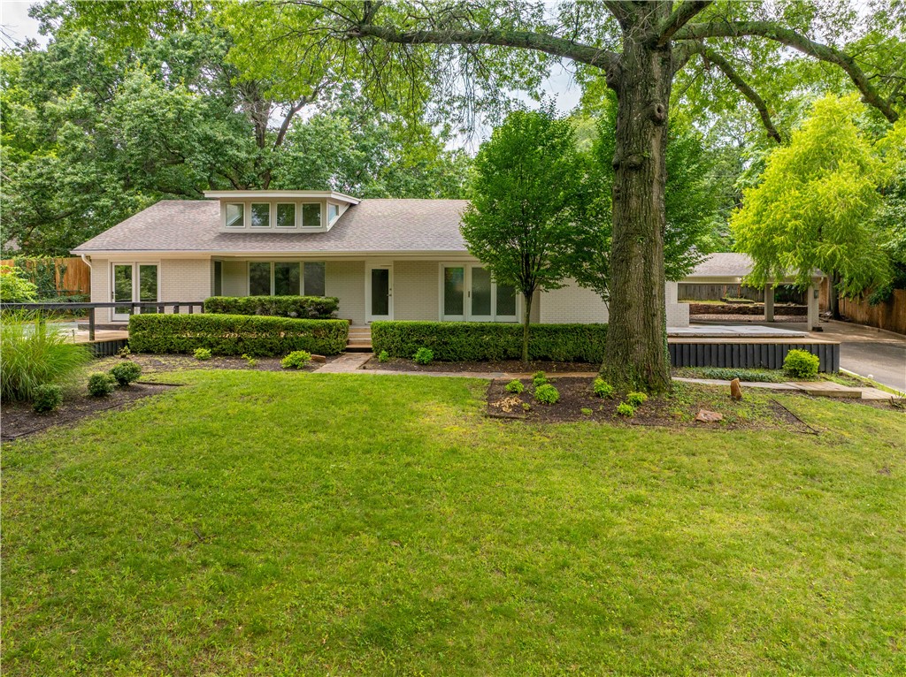 Tucked in one of Fayettevilleās most distinguished neighborhoods overlooking private Lake Lucille, this beautifully updated home offers the perfect blend of comfort, character, and convenienceājust minutes from downtown, the U of A, dining, and shopping. This 3-bedroom, 3-bath home offers a flexible layout, including a potential separate suite featuring its own living room, a wood-burning fireplace, and a private entranceāideal for guests, in-laws, or a home office. The primary suite opens directly to a heated pool, and the luxurious bath includes a soaking garden tub, walk-in shower, and dual vanities. Soaring vaulted ceilings, skylights, and an additional fireplace create an inviting atmosphere. Renovated in 2018, the kitchen is a chefās dream, with a large quartz island, stainless steel appliances, and ample storage. Enjoy peaceful mornings on the shaded front wood deck or the back flagstone patio. This home is a rare find in a prime location. KitchenAid refrigerator and W/D to convey.